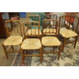 A harlequin set of six stained wood dining chairs with raffia seats, on square tapered front
