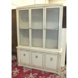 A modern white-painted and gilt dresser of three glazed doors, above three cupboard doors, 143cm