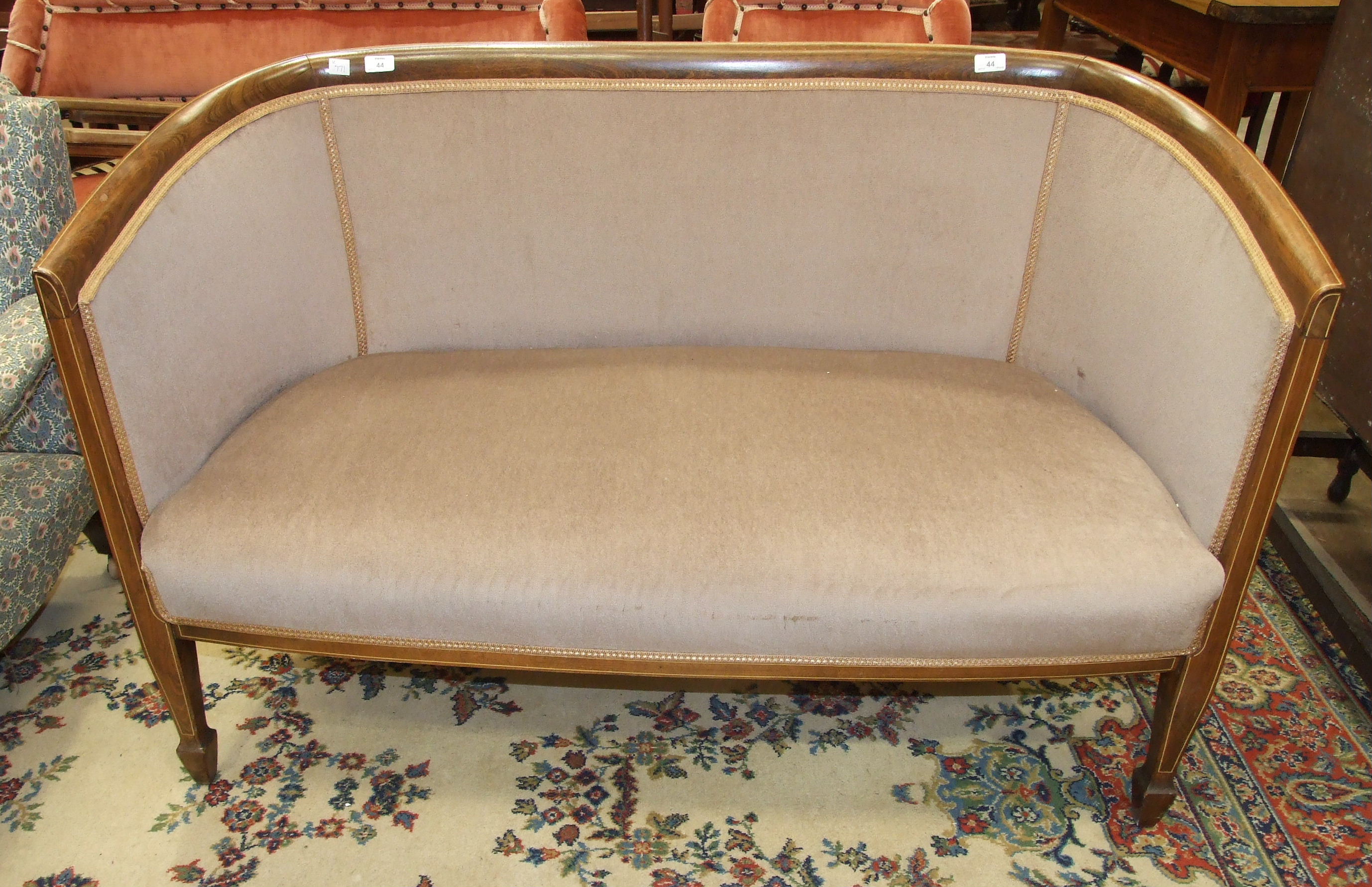 An Edwardian inlaid stained-beech upholstered hall seat, on square tapered front legs with spade