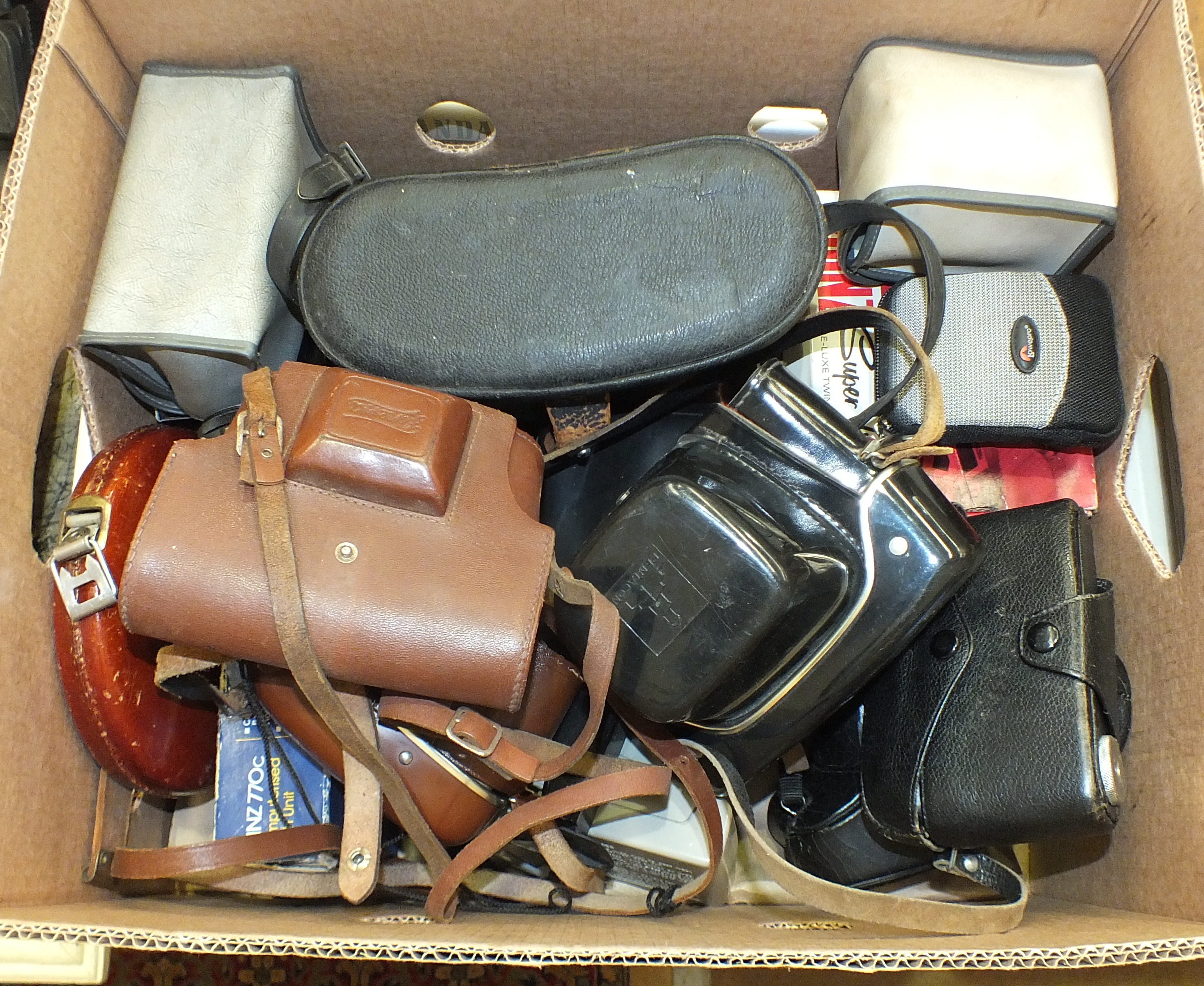 A pair of Chinon 10x50 binoculars in case and a collection of various cameras, including Praktica,