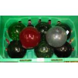 A collection of nine coloured glass fishing floats, (9).