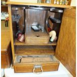 An Edwardian inlaid oak smoker's cabinet, the hinged lid and door revealing a fitted interior,