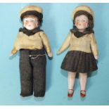 A pair of Edwardian all-bisque doll's house dolls, a boy and a girl, dressed in matching sailor