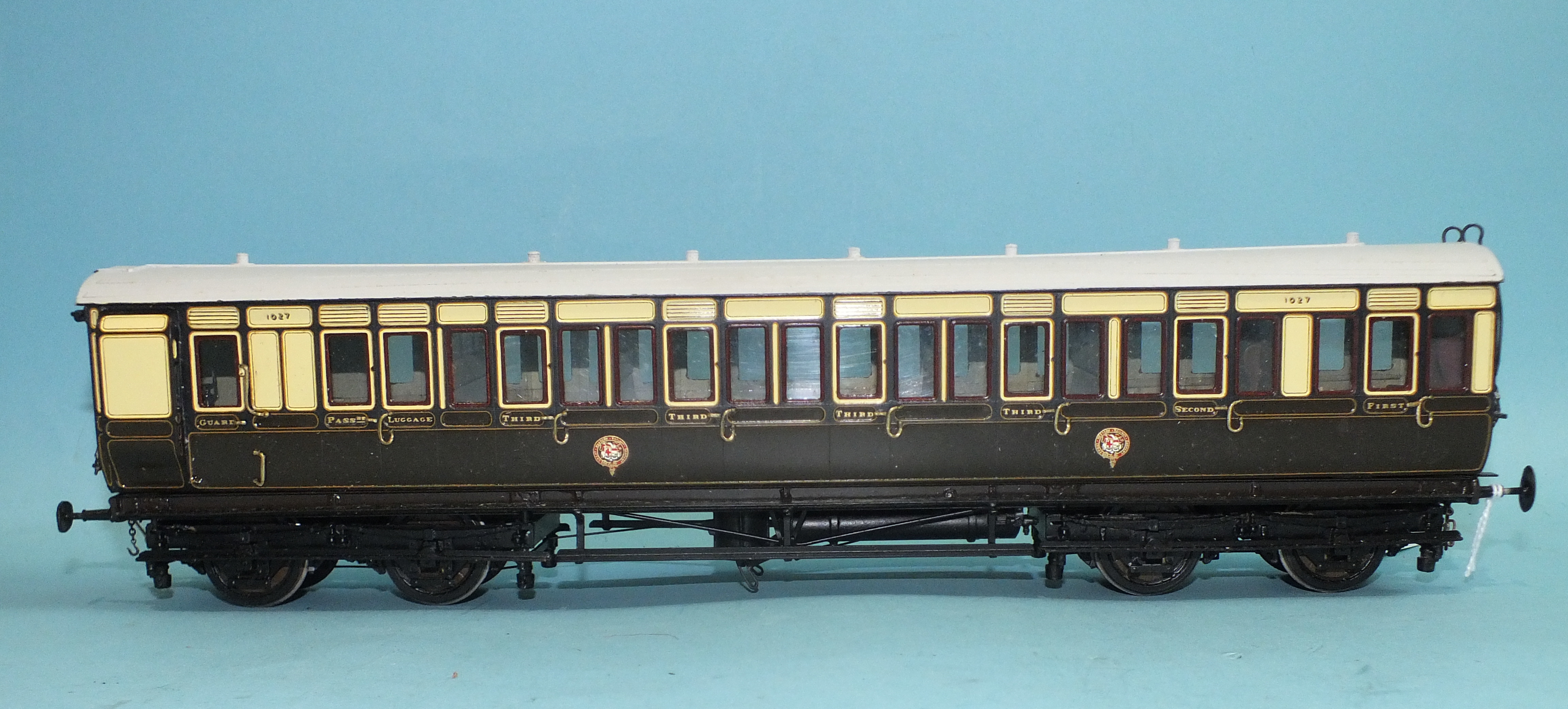 An O gauge kit-built brake/1st/3rd coach in GWR brown/cream livery, with interior detailing.