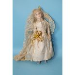 A Victorian wax over-composition shoulder head doll with inset glass eyes and blonde mohair wig, the