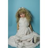 An Armand Marseille bisque head doll with sleeping blue eyes, (not working) and blonde mohair wig,