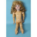 An SFBJ bisque head doll with sleeping blue glass eyes and blonde wig, on jointed composition