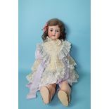 An Armand Marseille bisque head doll with sleeping brown eyes and brown mohair wig, on jointed