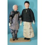 A pair of Chinese character dolls of padded wood and papier-mâché in the form of an elderly man