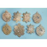 A collection of eight Scottish regiment badges, including Highlander XCI with twelve battle honours,