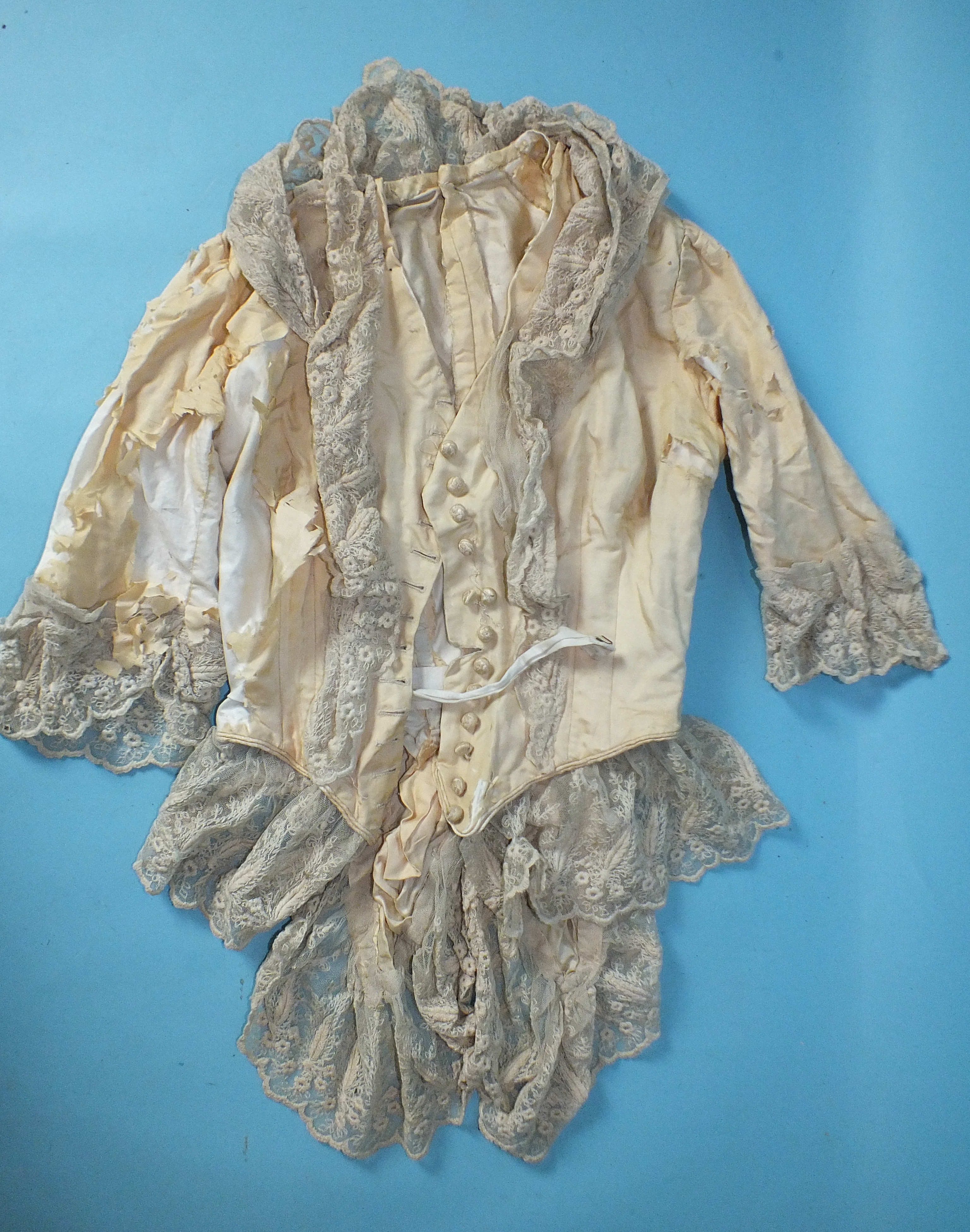 An 18th century ivory silk bodice in very poor condition, with late additions of lace, a 19th