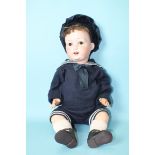 A Heubach Köppelsdorf bisque head baby doll with sleeping brown eyes and cropped brown mohair wig,