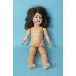 An Armand Marseille bisque head doll with sleeping brown eyes and real hair wig, on jointed