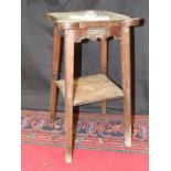 An oak two-tier occasional table, the square top with rounded corners and copper inset, applied with