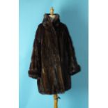 A lady's brown mink coat, three-quarter length, with turned-up cuffs and roll neck, labelled for