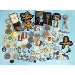 A collection of various metal medallions relating to Plymouth, including school attendance,