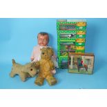 A Merrythought Terrier, 15cm high, a small golden plush teddy, a composition doll and other items.