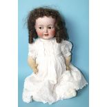 A Kammer & Reinhardt Simon & Halbig bisque baby head doll with brown flirty eyes, on jointed