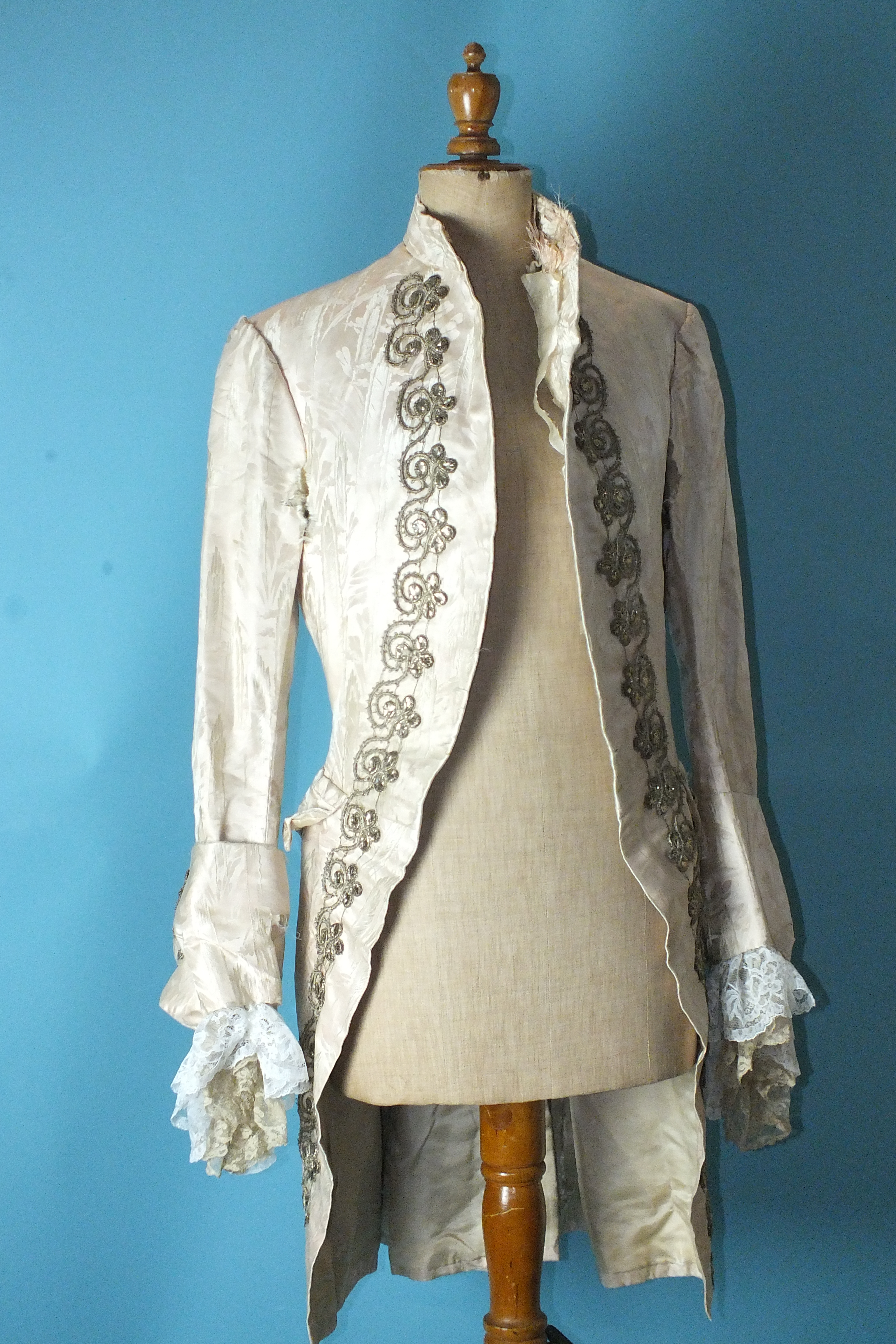 A late-18th century gentleman's very pale pink silk brocade coat, the front and cuffs embellished
