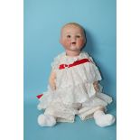 An Armand Marseille bisque head baby doll with sleeping blue eyes, on composition character body,