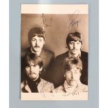 A photograph of the Beatles with facsimile signatures, an album of 16 black and white press