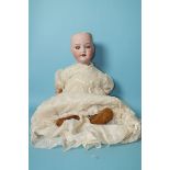 An Armand Marseille bisque head baby doll with sleeping blue eyes, no pate, on jointed composition