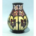 A Moorcroft Pottery ovoid shape vase decorated with stylised flowers, impressed and painted