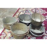 Five brass and metal-handled jam pans.