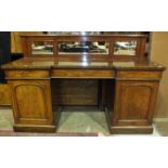 A Victorian mahogany pedestal sideboard, the mirrored low back above three frieze drawers and a pair