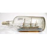 A ship in a bottle, three deck ship of the line, approximately 14.5cm long.