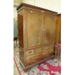 A late-19th century mahogany linen press with a pair of panelled doors, slides lacking, above