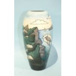 A Moorcroft Pottery baluster-shaped vase decorated with a coastal scene of cliffs and a sailing