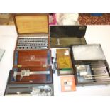 A collection of engineering tools, including Moore & Wright micrometers, precision ground square,