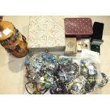 A quantity of earrings and other costume jewellery, with an earring stand and jewellery boxes.