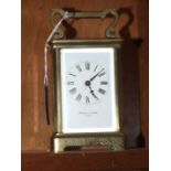 A late-19th/early-20th century French brass carriage timepiece with white enamel dial, signed Pearce