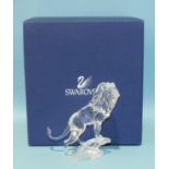 A Swarovski Crystal Lion standing on a rock, boxed.