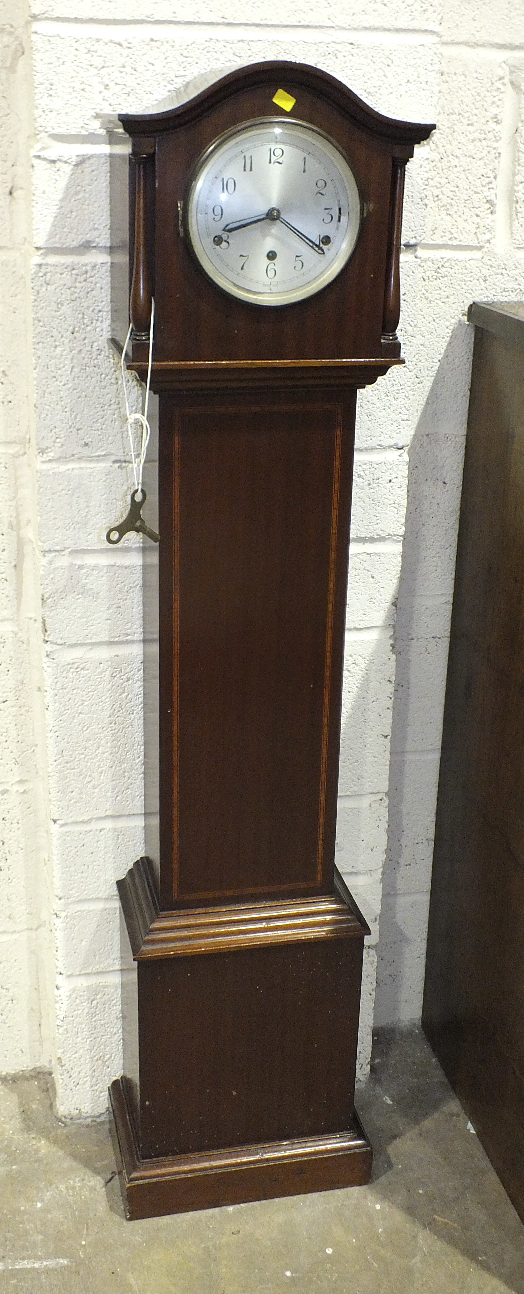 A 20th century mahogany chiming grandmother clock, 134cm high.