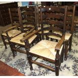 A set of six elm ladder-back chairs with rush seats, includes two armchairs, (6).