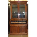 A Victorian mahogany cylinder bureau/bookcase, the slide-out writing drawer and fitted interior
