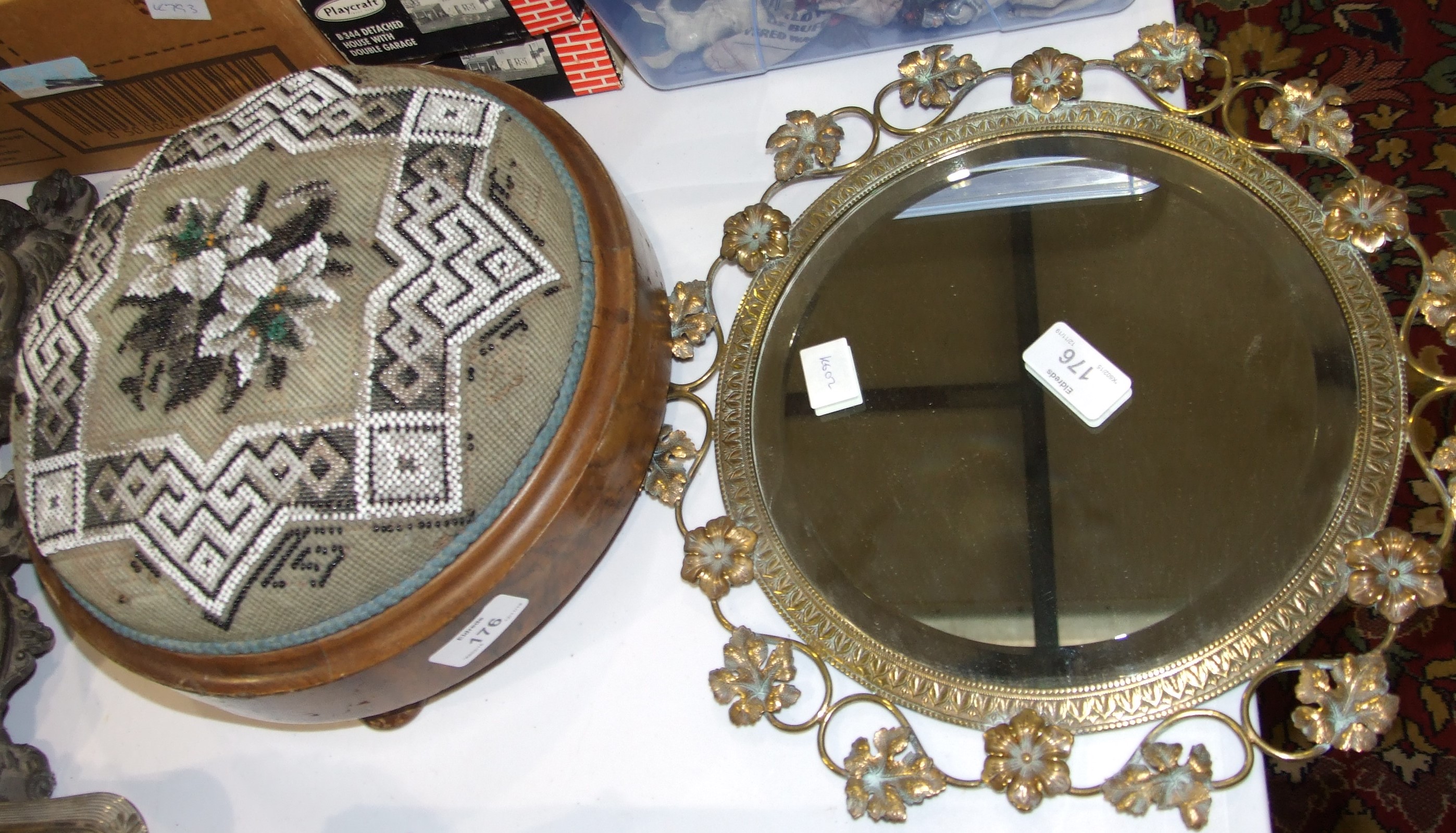 A late-Victorian circular brass mirror frame with later bevelled plate, 33cm diameter overall and