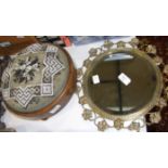 A late-Victorian circular brass mirror frame with later bevelled plate, 33cm diameter overall and