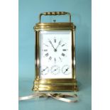 A 19th century French brass repeating carriage clock, the enamel dial with alarm, date and day of