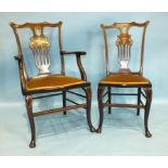 A pair of Edwardian mahogany armchairs, inlaid with ivory and boxwood, with padded serpentine