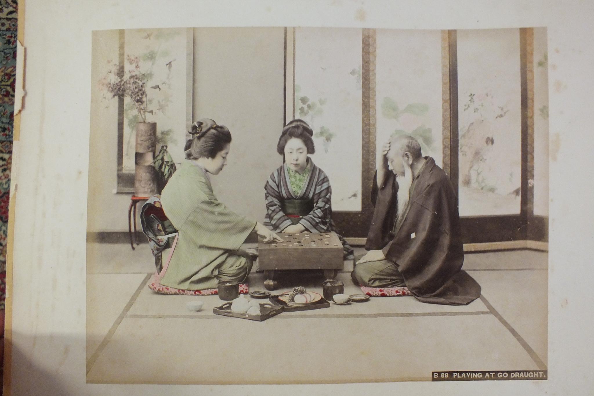 An early-20th century Japanese lacquered shibayama photograph album, containing fifty hand-tinted - Image 15 of 54