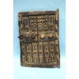 A carved wood panel with figural decoration, probably West African, fashioned as a cupboard door.