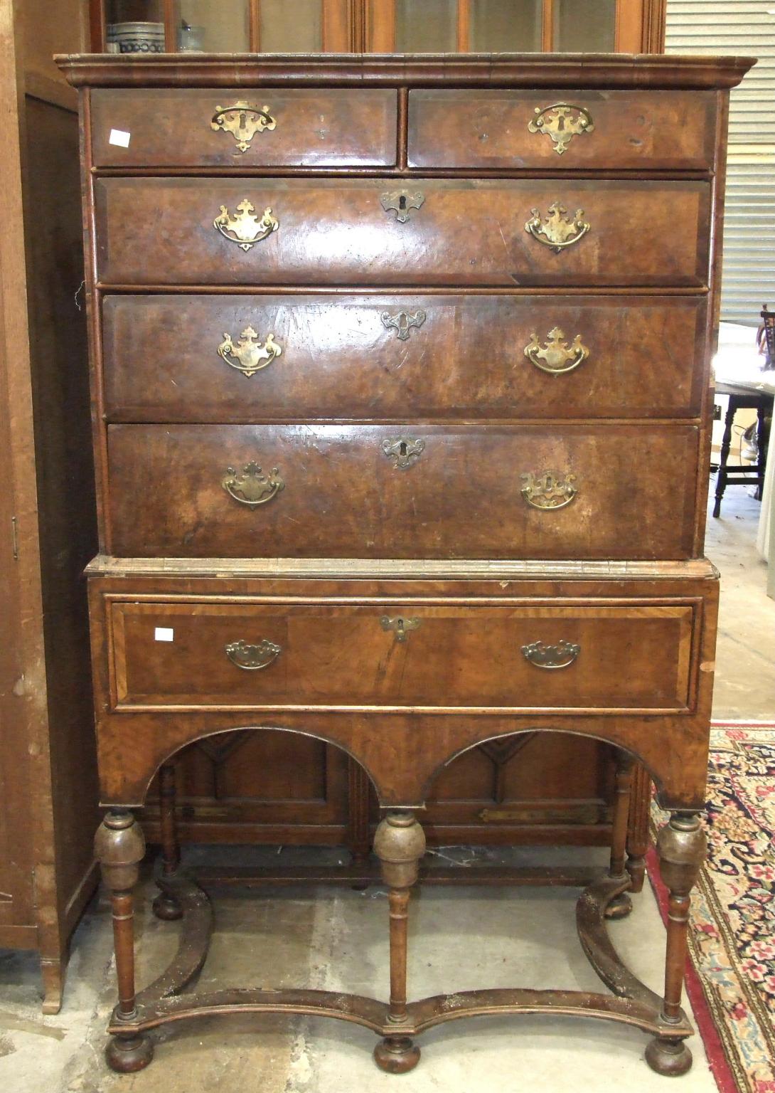 A mainly-18th century walnut chest on stand, the moulded cornice above two short and three long