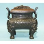 A Chinese bronze rectangular censer of archaic design, with lion dog feet and with a pierced