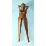 A carved-wood novelty nutcracker in the form of a female figure with articulated leg and other