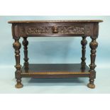 A 19th century carved oak serving table fitted with a frieze drawer, the legs joined by an