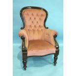 A Victorian mahogany salon chair with button back, on turned legs.